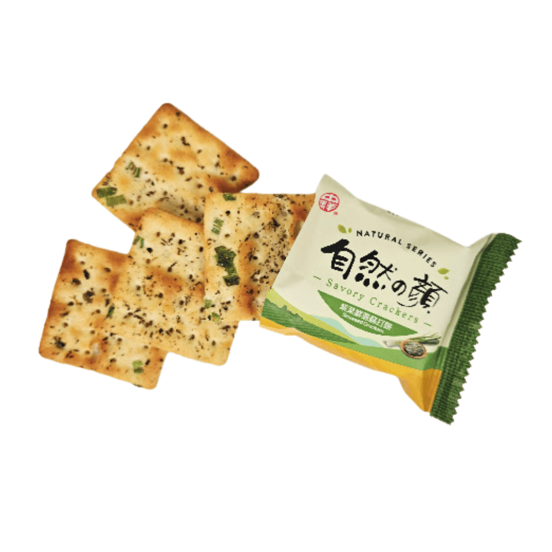 A green package of seaweed crackers with images of seaweed and green onions, with 4 crackers coming out of the package.